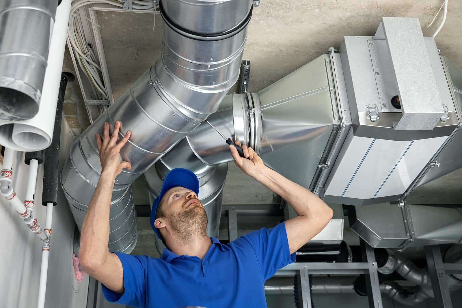 HVAC technician inspecting and repairing air ducts in Union City
