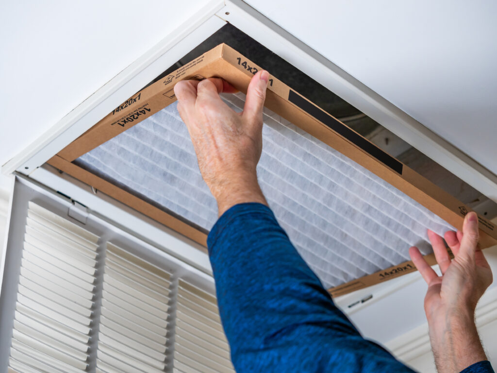 HVAC technician replacing a home air filter in Union City
