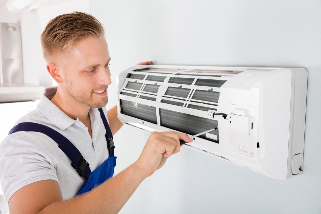 HVAC technician maintaining a ductless air conditioner in Union City