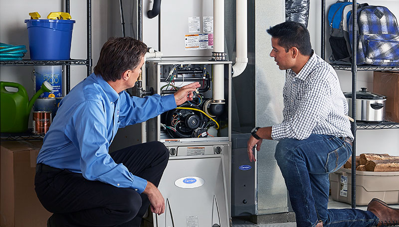 Technician evaluating a furnace for repair or replacement in Union City
