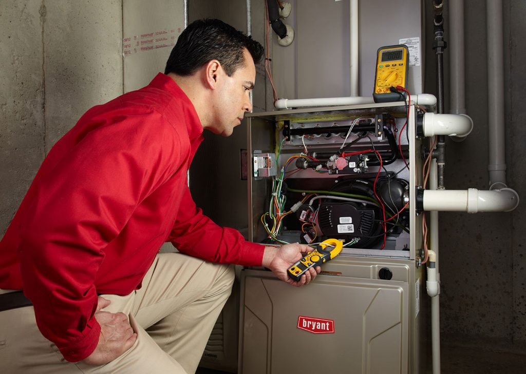 Heating technician diagnosing a furnace repair in Union City