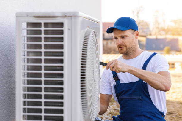 HVAC technician servicing an outdoor air conditioner in Union City