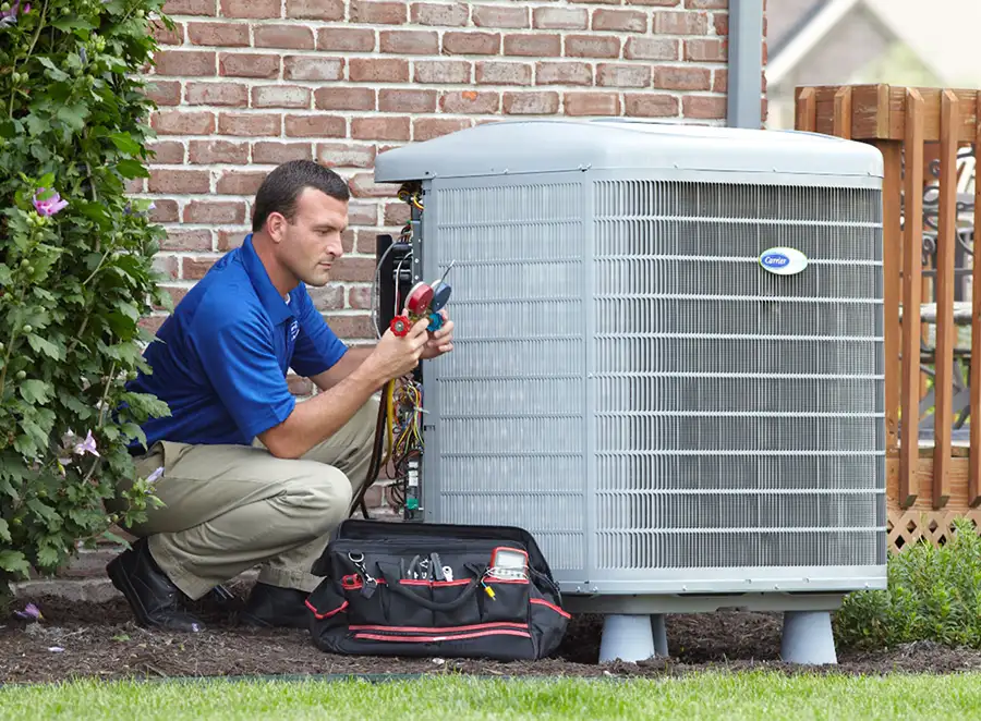HVAC technician inspecting an outdoor AC unit in Union City