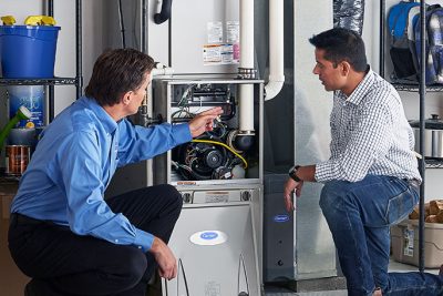 Furnace Repair or Replacement Union City Technician evaluating a furnace for repair or replacement in Union City