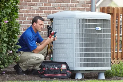 Outdoor AC Unit Inspection Union City HVAC technician inspecting an outdoor AC unit in Union City